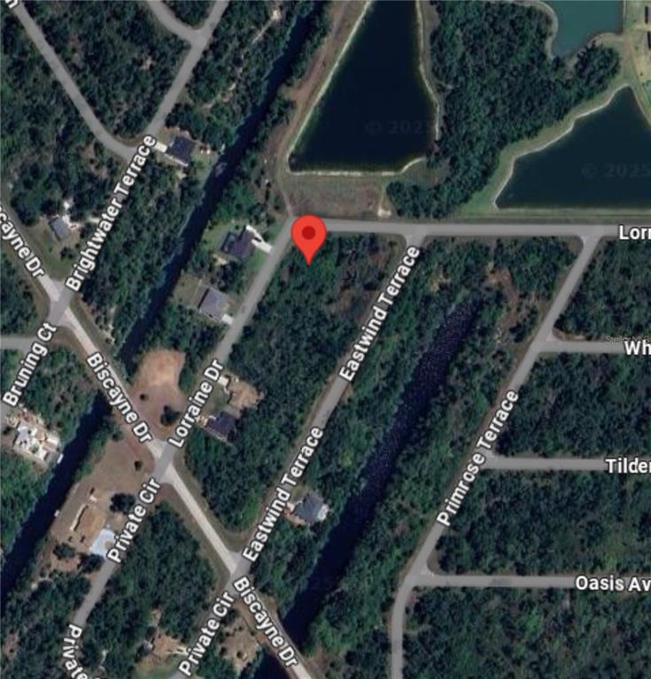 This is a satellite map view showing a vacant residential lot marked with a pin — 2120 LORRAINE DRIVE, PORT CHARLOTTE, FL