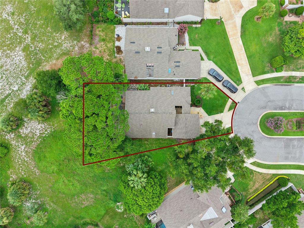An aerial view shows a residential house with a large tree on a corner lot — 2538 LONG IRON COURT, LONGWOOD, FL