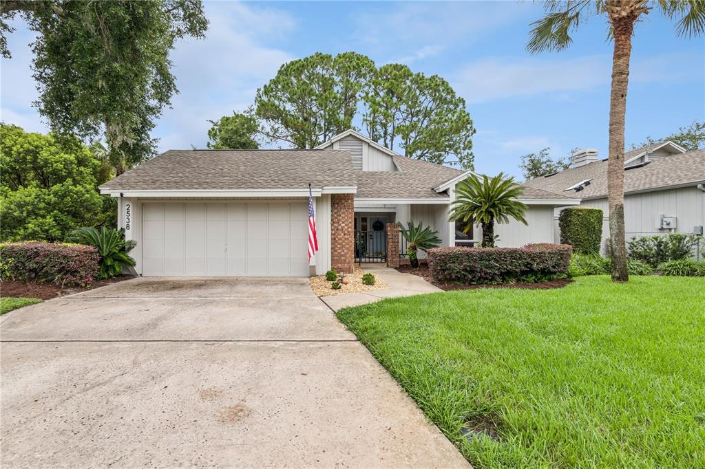 A single-story house with a two-car garage, brick accents, and a front lawn — 2538 LONG IRON COURT, LONGWOOD, FL