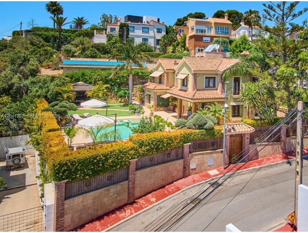 An aerial view of a two-story villa with a swimming pool and landscaped garden — 29018 MALAGA, ESPAIN, FL