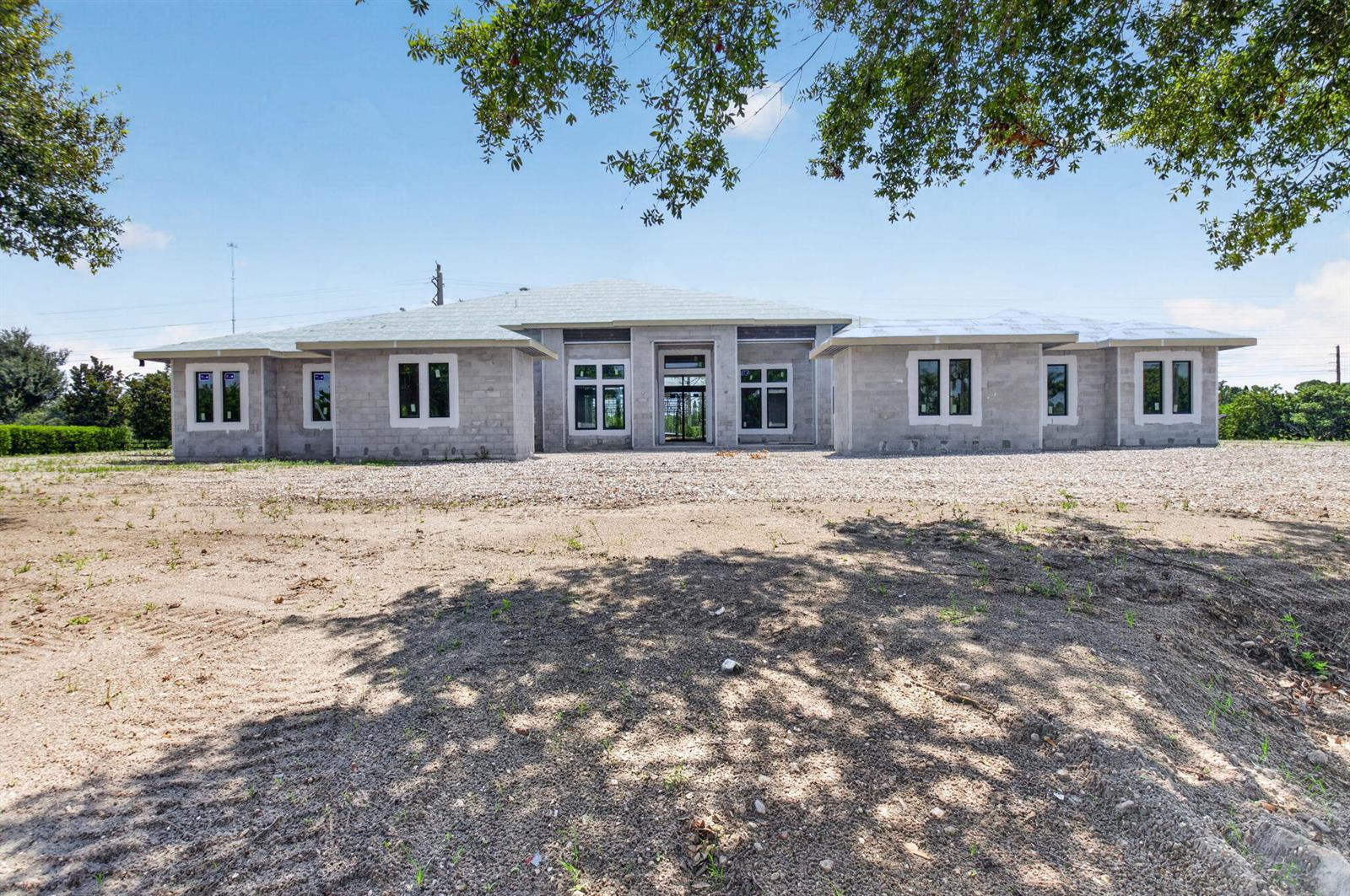 A single-story house under construction with concrete block walls and installed windows — 6450 Sugarcane Lane, Lake Worth FL 33449, LAKE WORTH, FL