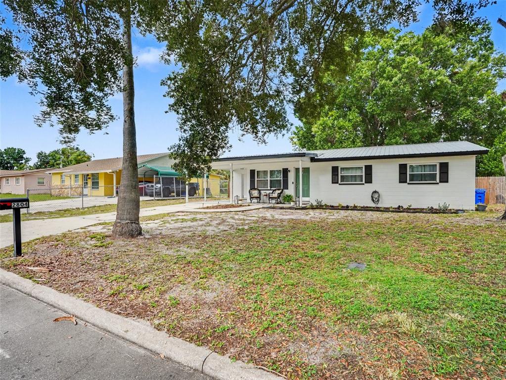 A dining area with tile floors, a wooden table, and a sliding glass door — 2804 KATHRYN AVENUE, LAKELAND, FL