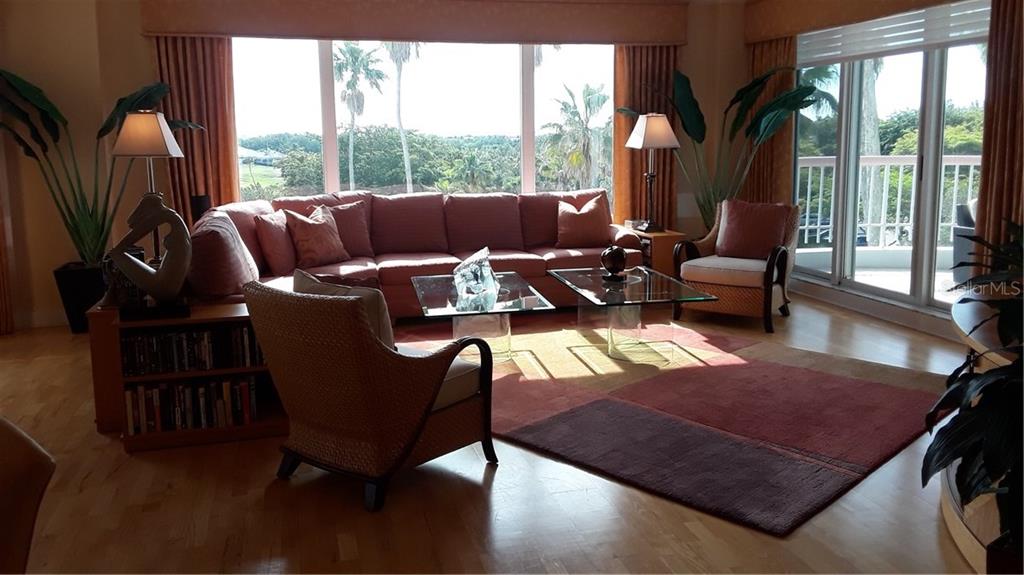 A living room features a large sectional sofa, two glass coffee tables, and floor-to-ceiling windows — 455 LONGBOAT CLUB ROAD UNIT 401, LONGBOAT KEY, FL