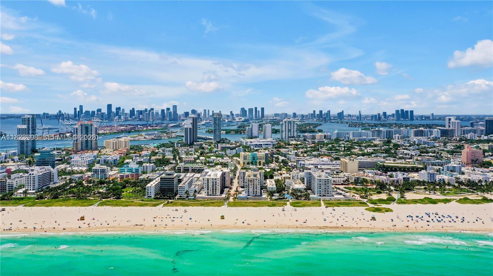 An aerial view of a sandy beach, turquoise ocean, and the Miami skyline — 401 Ocean Dr # 722, Miami Beach FL 33139, MIAMI BEACH, FL