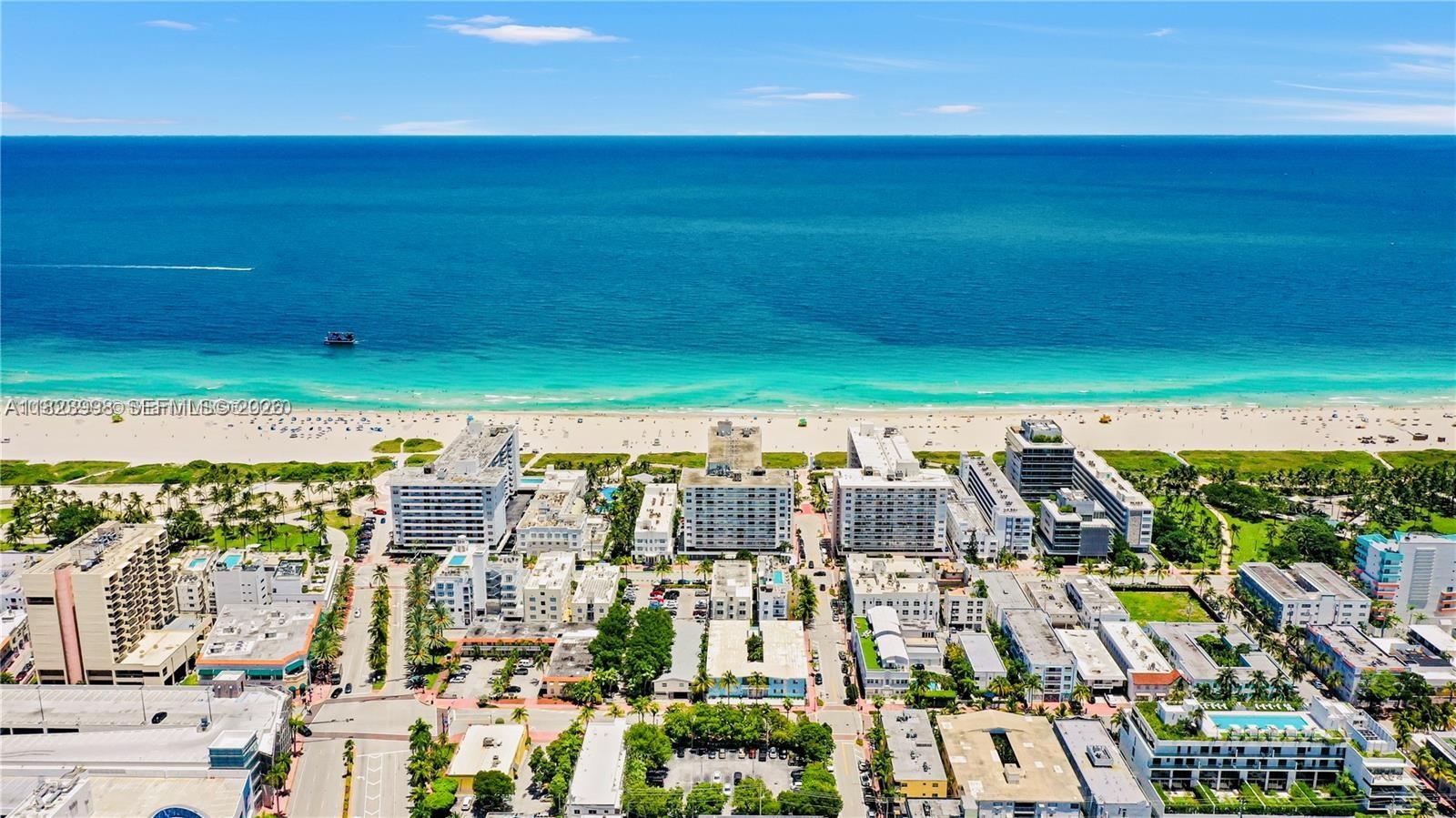 An aerial view shows a beach with turquoise water and surrounding multi-story buildings — 401 Ocean Dr # 722, Miami Beach FL 33139, MIAMI BEACH, FL