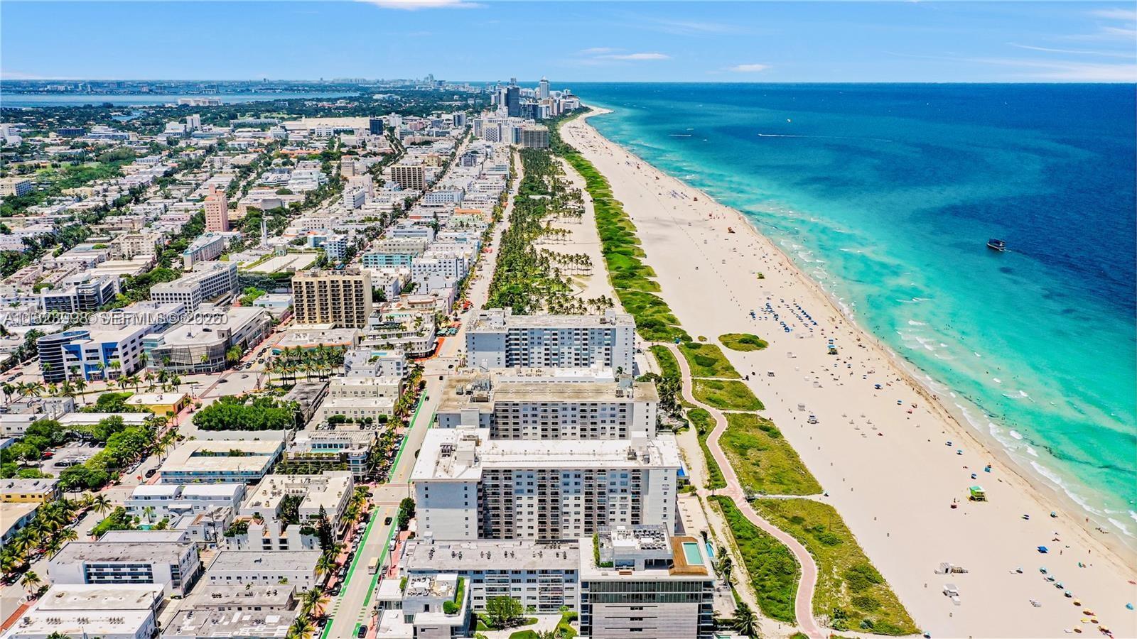 An aerial view of a coastal city with high-rise buildings bordering a sandy beach — 401 Ocean Dr # 722, Miami Beach FL 33139, MIAMI BEACH, FL