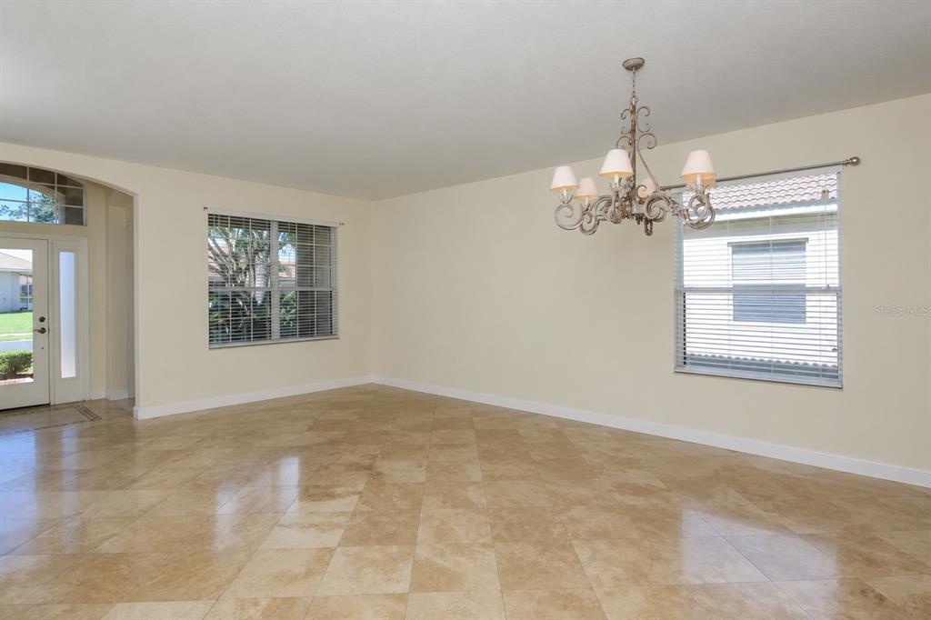 A dining room with tile flooring, a chandelier, and windows with blinds — 6945 74TH STREET CIRCLE E, BRADENTON, FL
