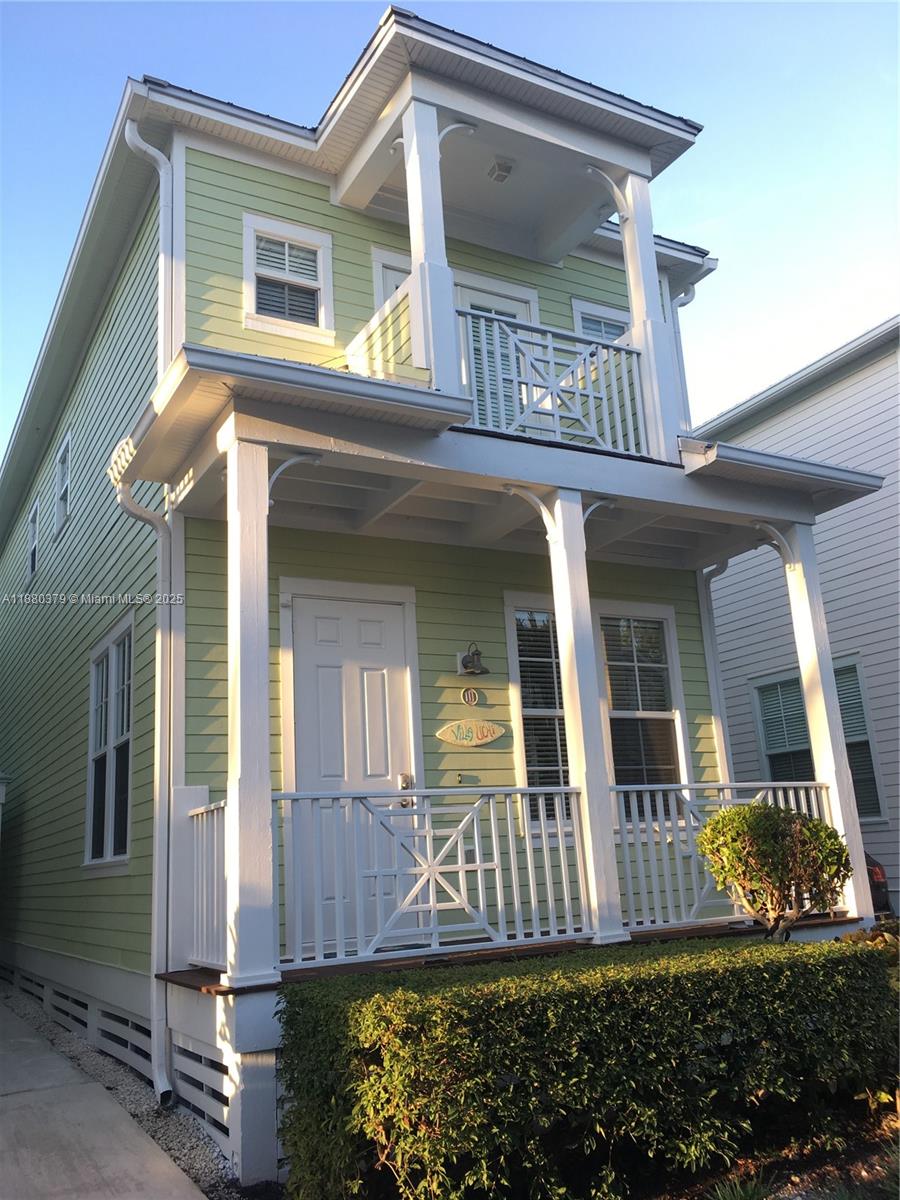 A two-story light green house with a front porch and a second-floor balcony — 111 Anglers Way, Islamorada FL 33036, ISLAMORADA, FL