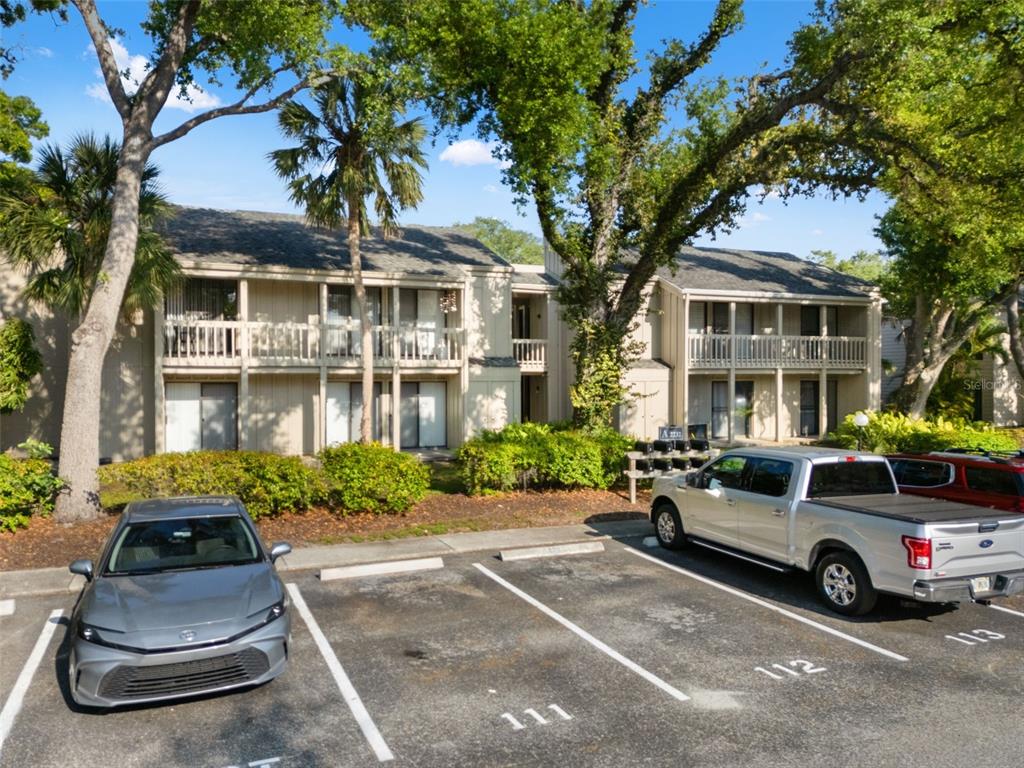 A two-story apartment building with a parking lot in the foreground — 2232 BAHIA VISTA STREET UNIT A1, SARASOTA, FL