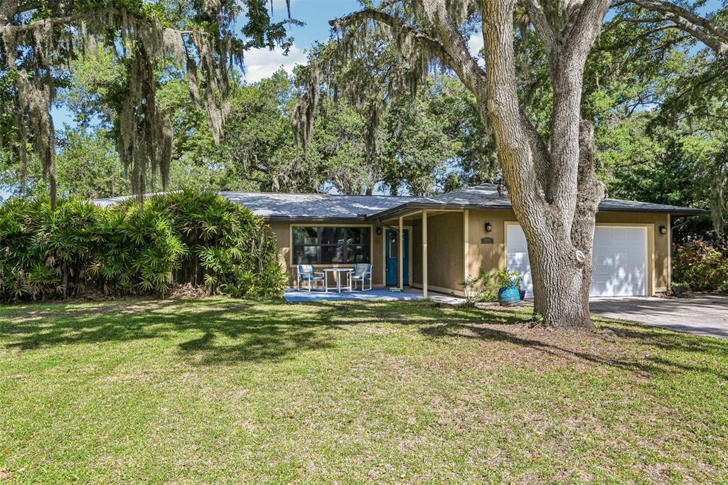 A single-story house with a garage and a large front lawn under mature oak trees — 3304 SWAAN LANE, SARASOTA, FL