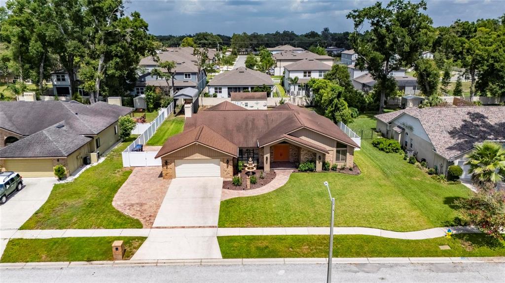 An aerial view of a suburban single-story house with a brown roof and concrete driveway — 2001 CIMMARON RUN DRIVE, VALRICO, FL