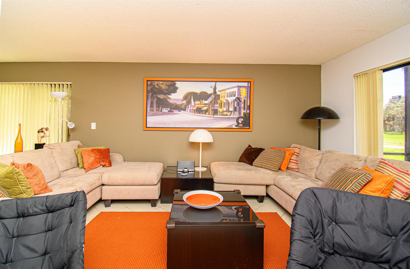 A living room features two beige sectional sofas, a coffee table, and a wall painting — 8334 Cypress Lane # 1a, Boca Raton FL 33433, BOCA RATON, FL
