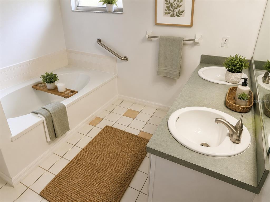 A bathroom features a soaking tub, a double vanity with green countertops, and tiled flooring — 505 DEEN STILL ROAD, DAVENPORT, FL