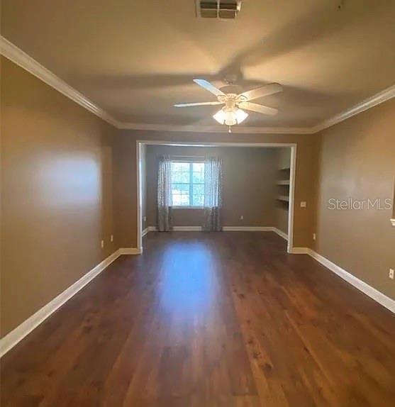 An empty room with wood-look flooring, a ceiling fan, and a window with curtains — 1301 EASTERN PECAN PLACE UNIT 208, WINTER GARDEN, FL