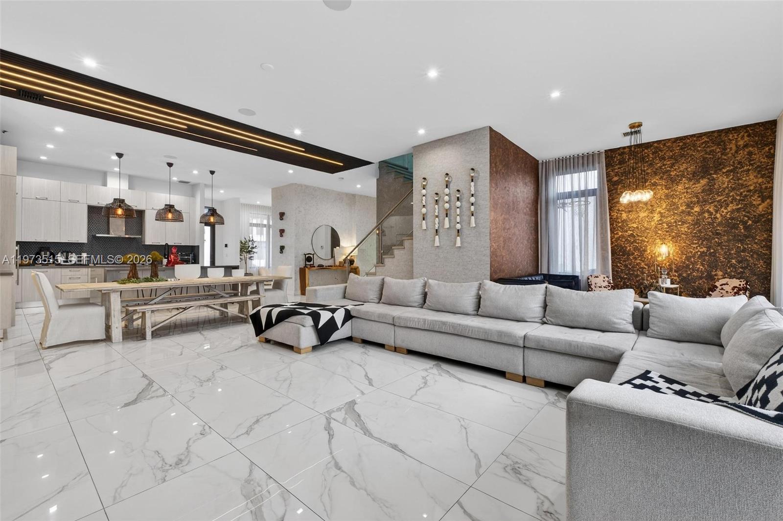 A modern open-concept living room and kitchen featuring marble tile floors and a large sectional — 8126 NW 48th Ter, Doral FL 33166, DORAL, FL