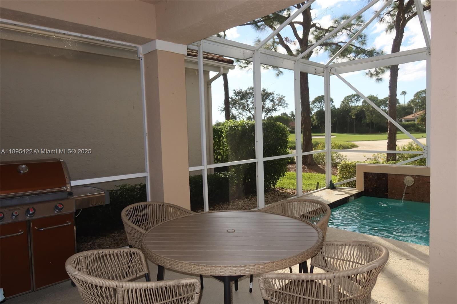A screened-in patio features a dining set, a grill, and a small swimming pool — 8189 Sandpiper Way, West Palm Beach FL 33412, WEST PALM BEACH, FL