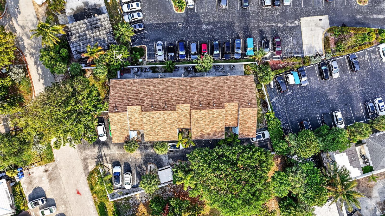 An aerial view shows a multi-unit building with a brown shingled roof and parking lots — 3250 NE 12th Street NE # 6, Pompano Beach FL 33062, POMPANO BEACH, FL
