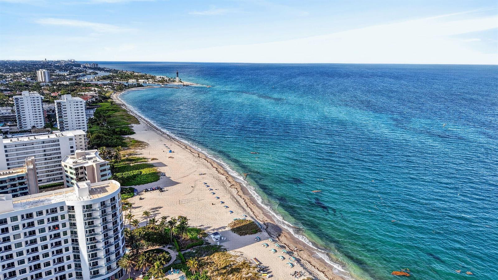 An aerial view of a sandy beach coastline with high-rise buildings and a lighthouse — 3250 NE 12th Street NE # 6, Pompano Beach FL 33062, POMPANO BEACH, FL
