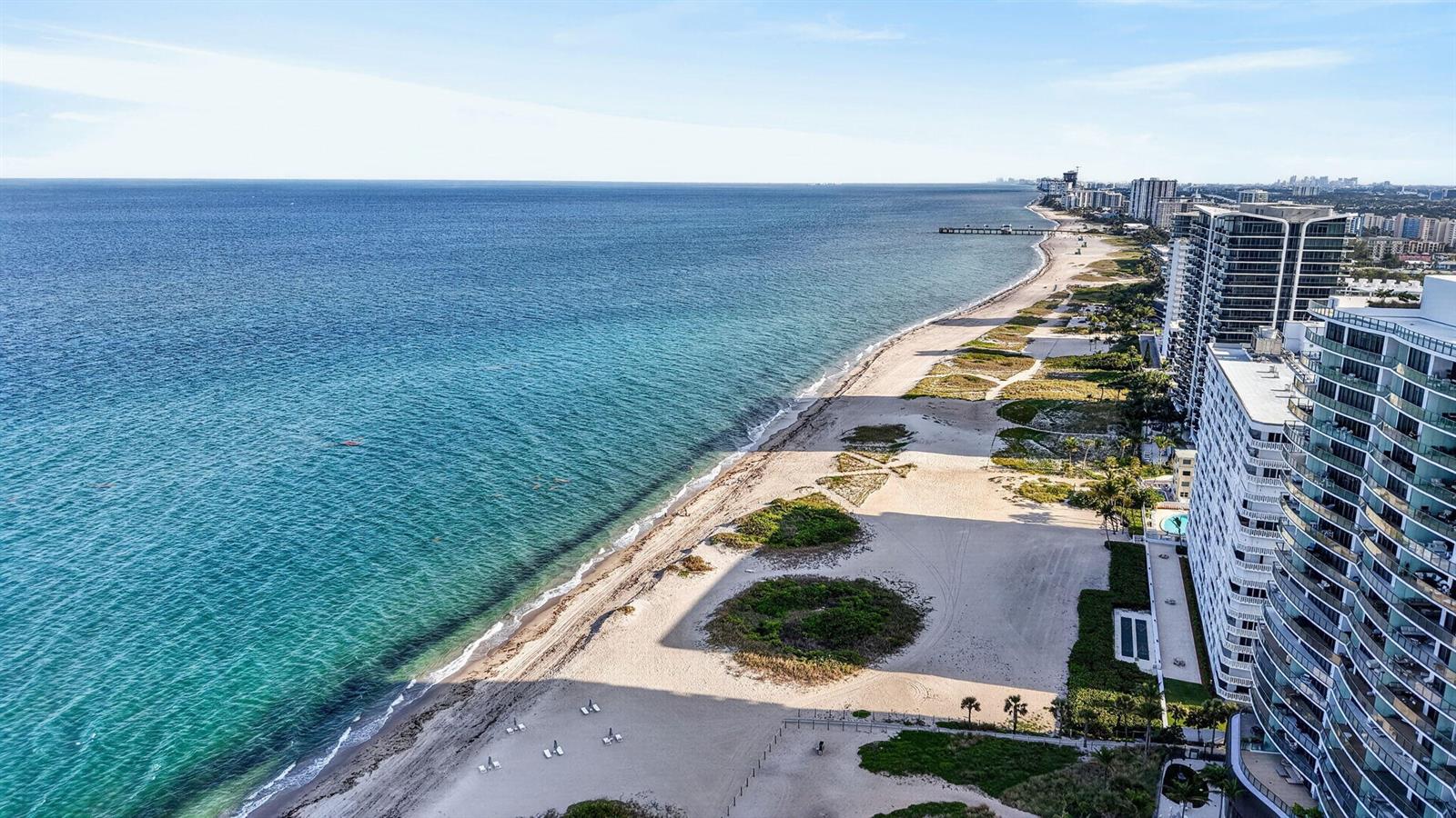 An aerial view of a sandy beach next to high-rise buildings and the ocean — 3250 NE 12th Street NE # 6, Pompano Beach FL 33062, POMPANO BEACH, FL