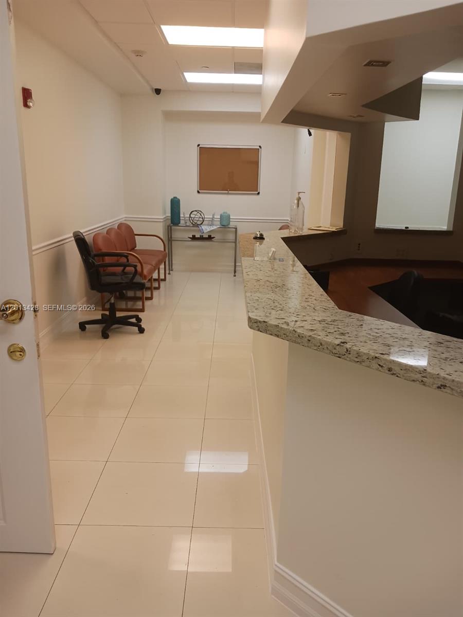 This office reception area features a granite-topped counter, tile flooring, and a waiting area — 13155 SW 42nd St # 112, Miami FL 33175, MIAMI, FL