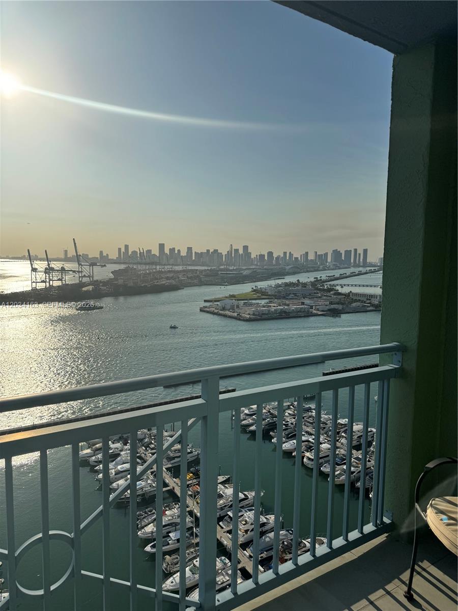 A high-angle view from a balcony overlooking a marina, a shipping port, and a city skyline — 90 ALTON RD # 2908, Miami Beach FL 33139, MIAMI BEACH, FL