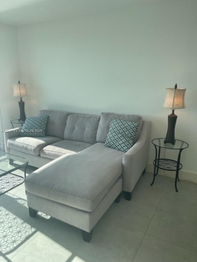 A gray sectional sofa sits between two side tables with lamps in a living room — 90 ALTON RD # 2908, Miami Beach FL 33139, MIAMI BEACH, FL