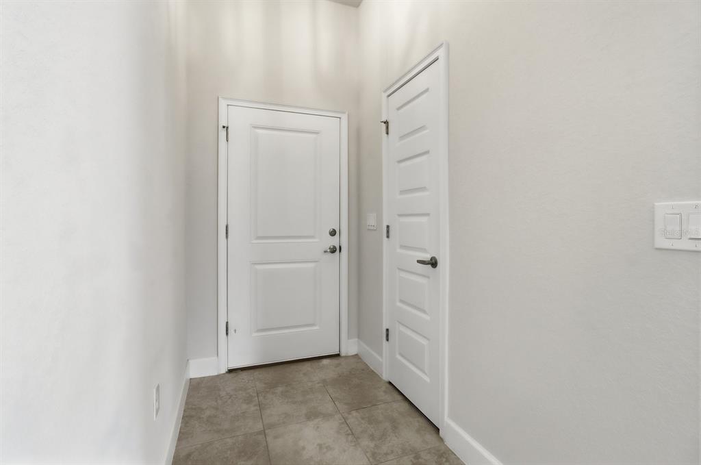 A white front door and a closed interior door sit in a tiled entryway — 4493 NW 2ND COURT, OCALA, FL