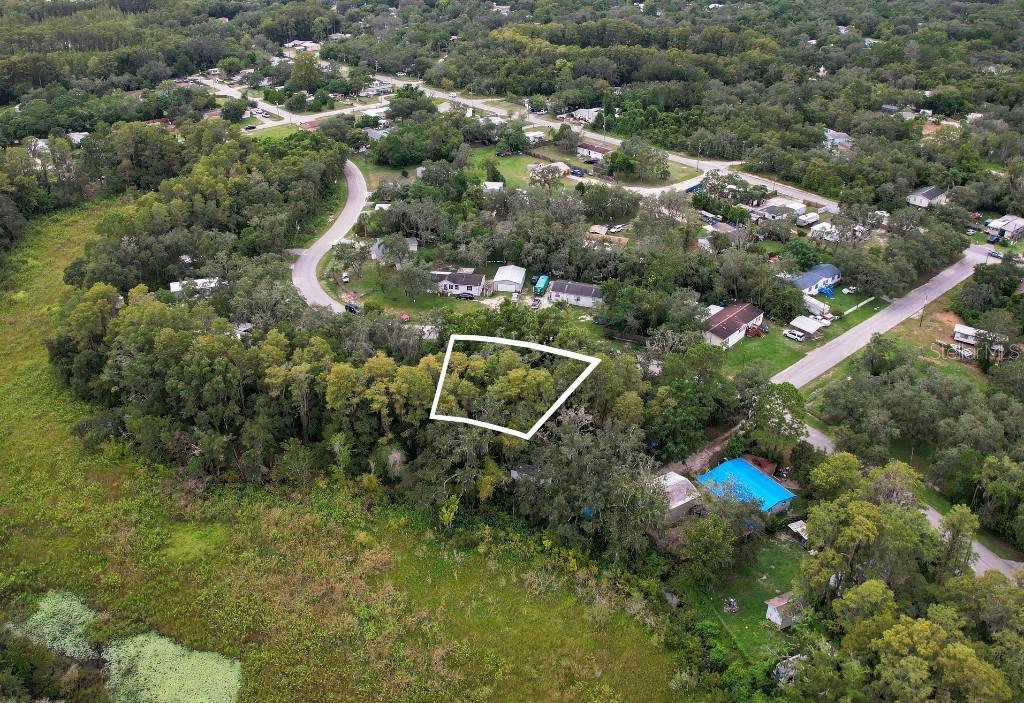 An aerial view shows a wooded, rectangular plot of land outlined in white — 33 POPLAR STREET, NEW PORT RICHEY, FL