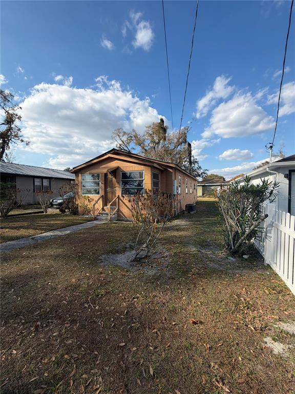 A single-story brick house with a front porch stands on a grassy lot — 3908 E GENESEE STREET, TAMPA, FL