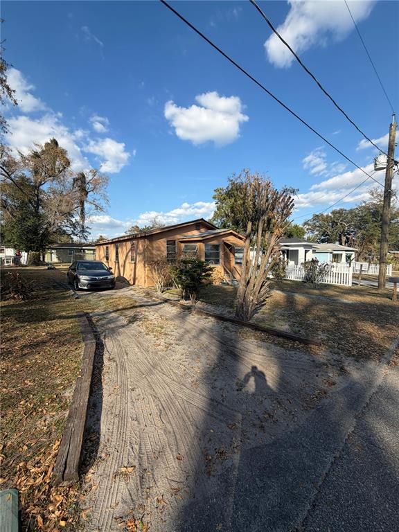 A single-story house with a sandy driveway and a car parked in front — 3908 E GENESEE STREET, TAMPA, FL