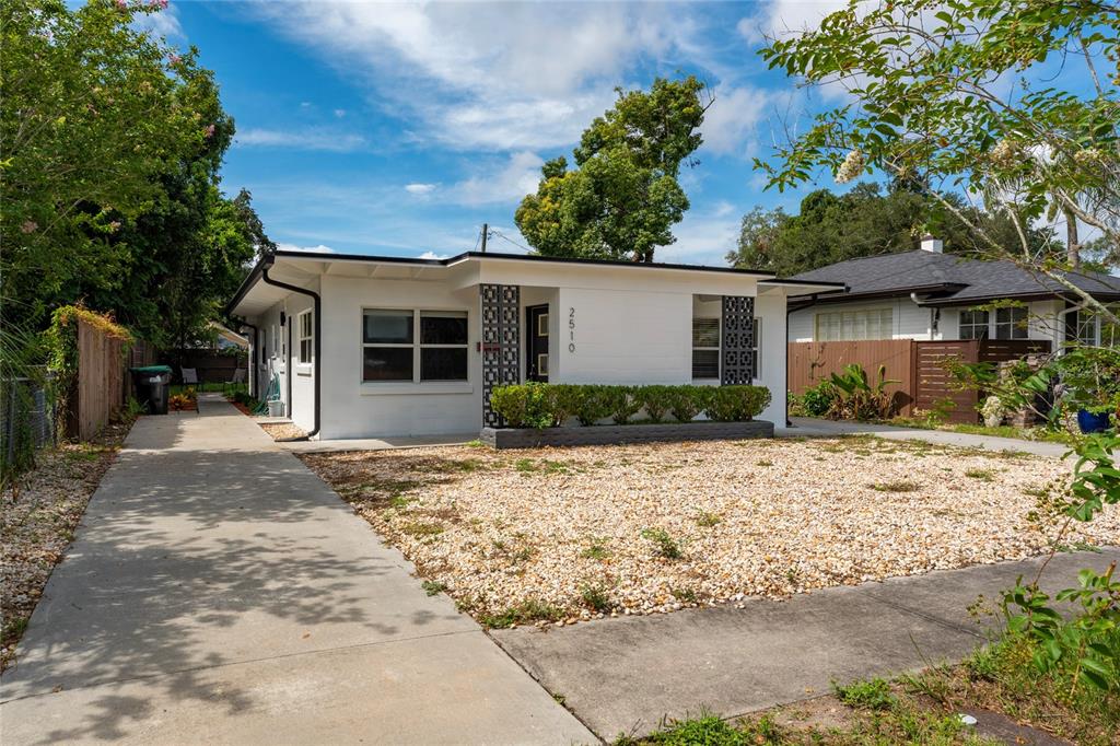 A white single-story house with a gravel front yard and a concrete driveway — 2510 BOYD AVENUE, ORLANDO, FL