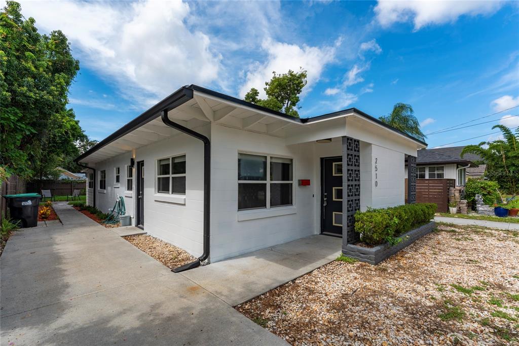 A white single-story house features a concrete driveway, a decorative block pillar, and a front door — 2510 BOYD AVENUE, ORLANDO, FL