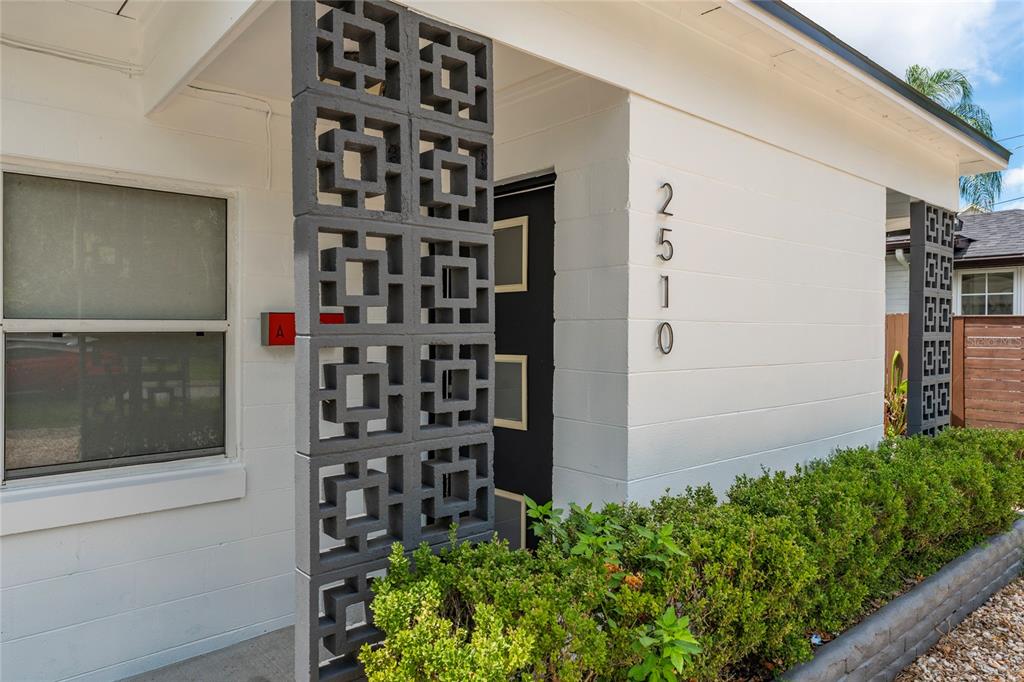 A white exterior wall features a decorative concrete block screen and the house number 2510 — 2510 BOYD AVENUE, ORLANDO, FL
