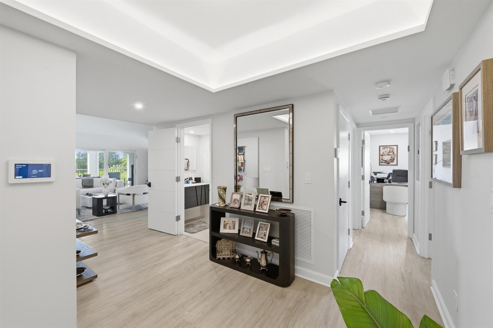 A bright hallway with light wood flooring leads to a living area and office space — 7369 Orangewood Lane, Boca Raton FL 33433, BOCA RATON, FL