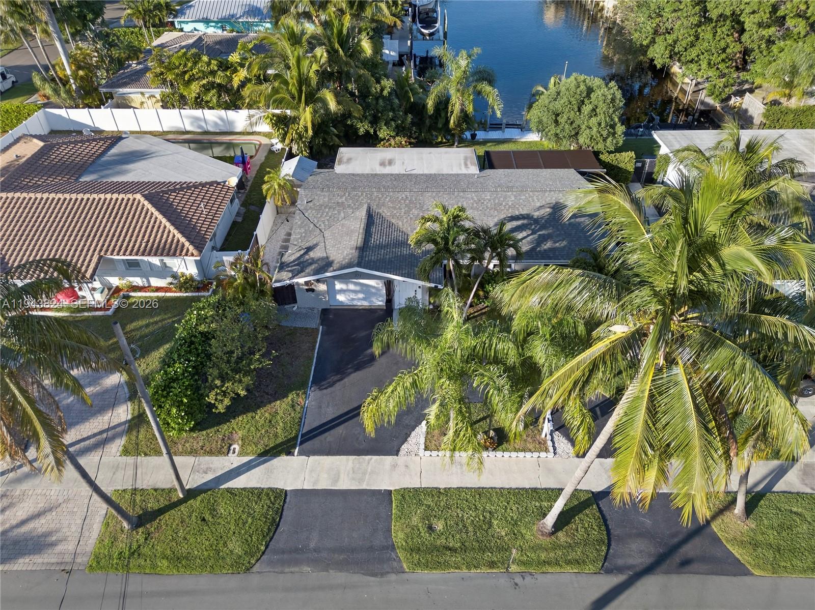 An aerial view shows a single-story house with a gray roof and a paved driveway — 371 SE 3rd St, Pompano Beach FL 33060, POMPANO BEACH, FL