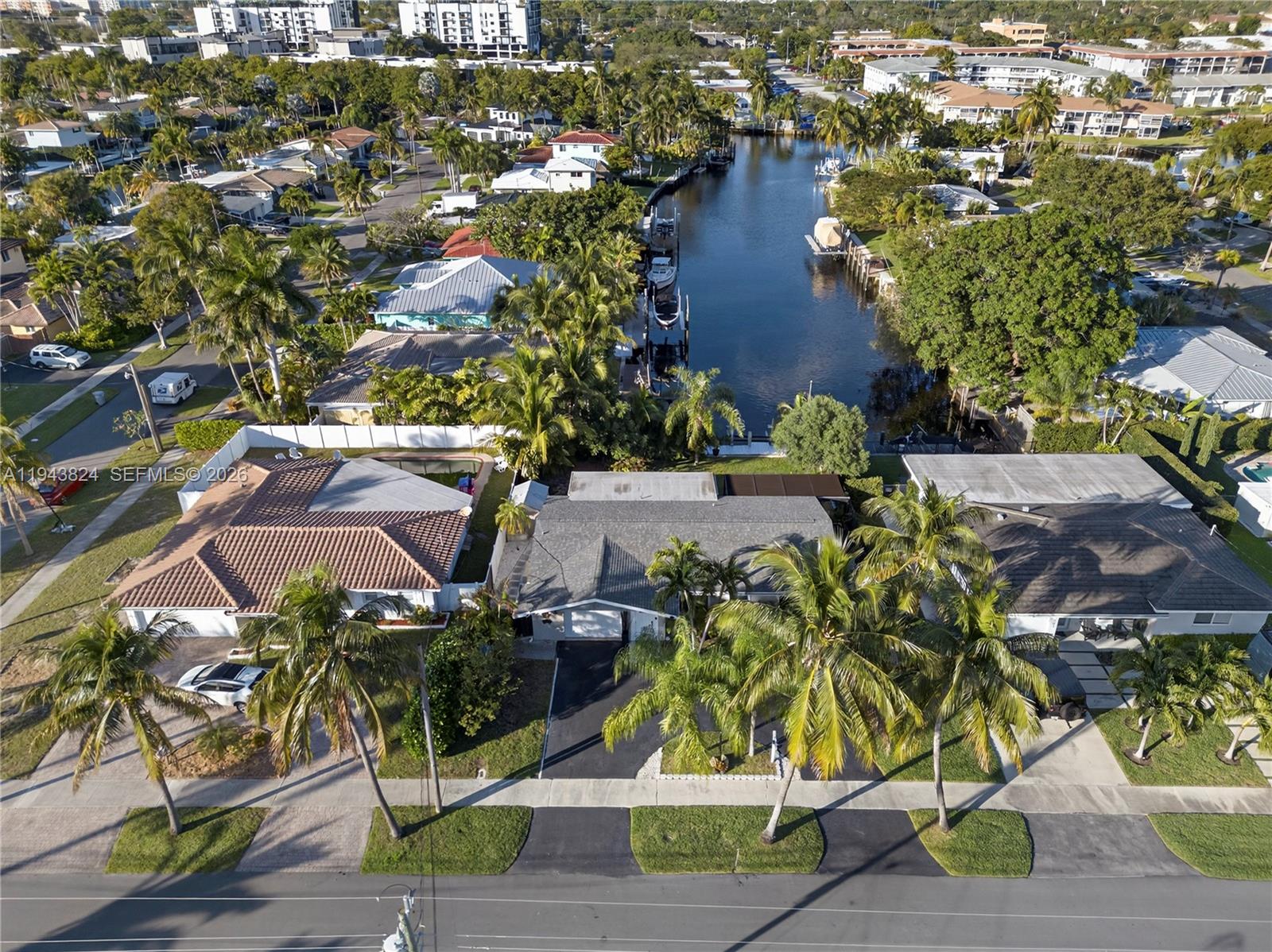 An aerial view shows a residential street with houses, palm trees, and a canal — 371 SE 3rd St, Pompano Beach FL 33060, POMPANO BEACH, FL