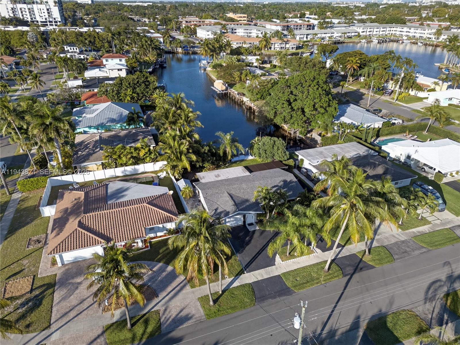 An aerial view shows residential houses with palm trees along a canal in Florida — 371 SE 3rd St, Pompano Beach FL 33060, POMPANO BEACH, FL