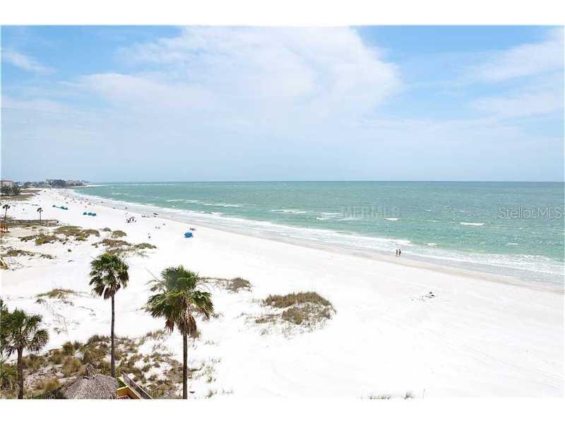 A high-angle view of a white sand beach with palm trees and the ocean — 13650 GULF BOULEVARD UNIT 304, MADEIRA BEACH, FL