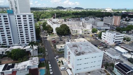 An aerial view shows a city street lined with multi-story buildings, parking lots, and trees — #541-#559 SERGIO CUEVAS BUSTAMENTE, HATO REY WARD, SAN JUAN, PR