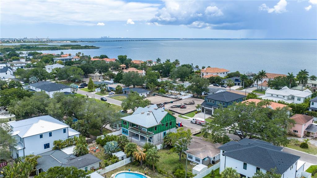 An aerial view shows a coastal neighborhood with several houses, including one under construction — 3606 S BELCHER DRIVE, TAMPA, FL