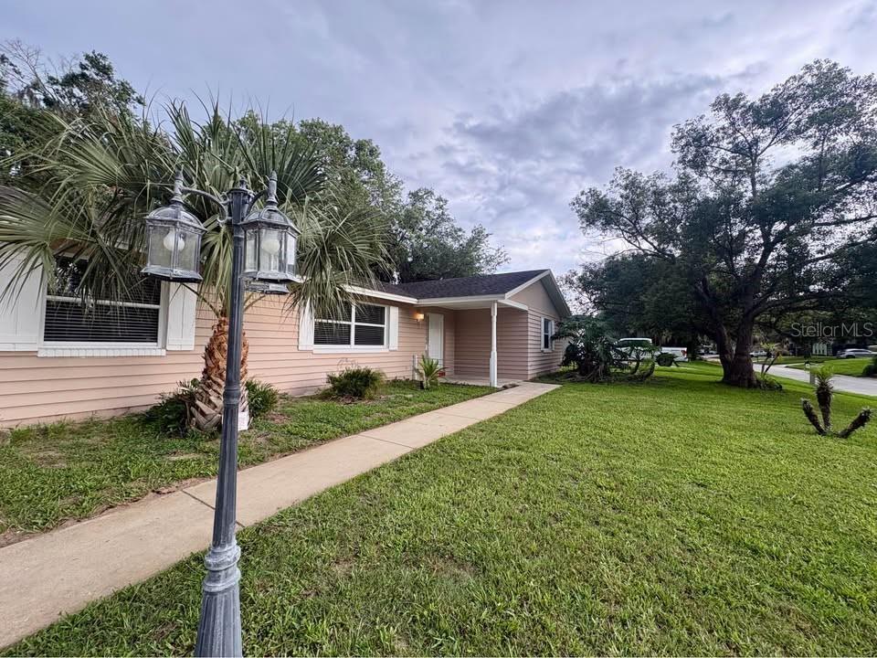 A single-story house with light-colored siding, a front walkway, and a decorative lamp post — 39 PINE VALLEY CIRCLE, ORMOND BEACH, FL