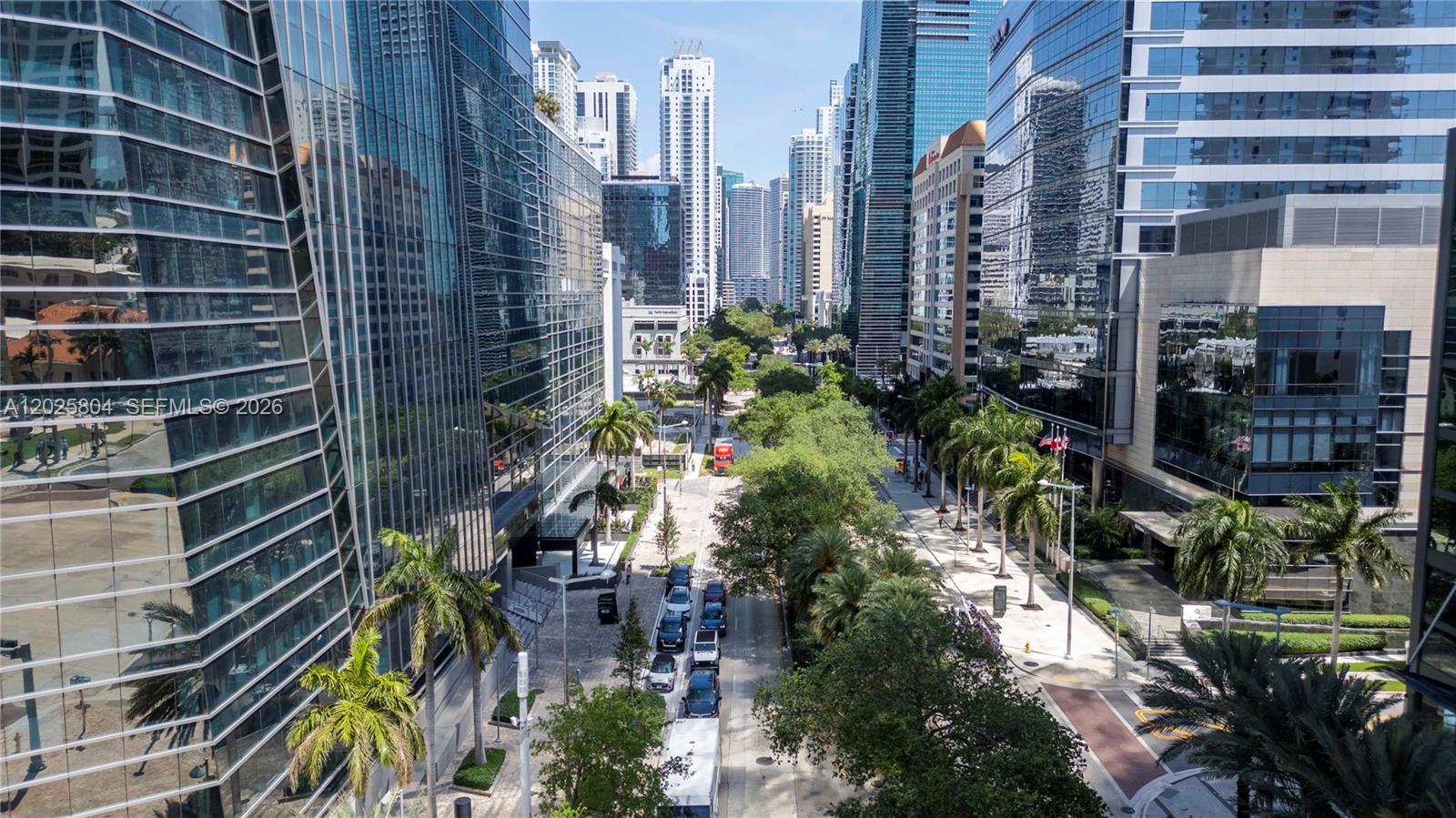 An elevated view of a city street lined with modern glass skyscrapers and palm trees — 1451 Brickell Ave # 2606, Miami FL 33131, MIAMI, FL