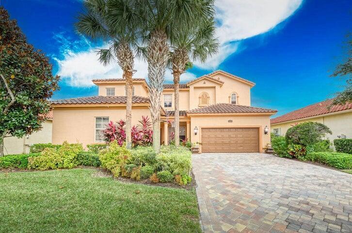 A two-story stucco house with a tiled roof, palm trees, and a paved driveway — 5574 55th Avenue, Vero Beach FL 32967, VERO BEACH, FL