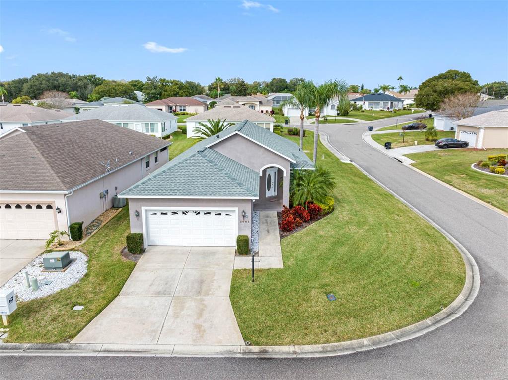 An aerial view of a single-story suburban house with a gray roof and driveway — 3063 WESTMORELAND DRIVE, LAKELAND, FL