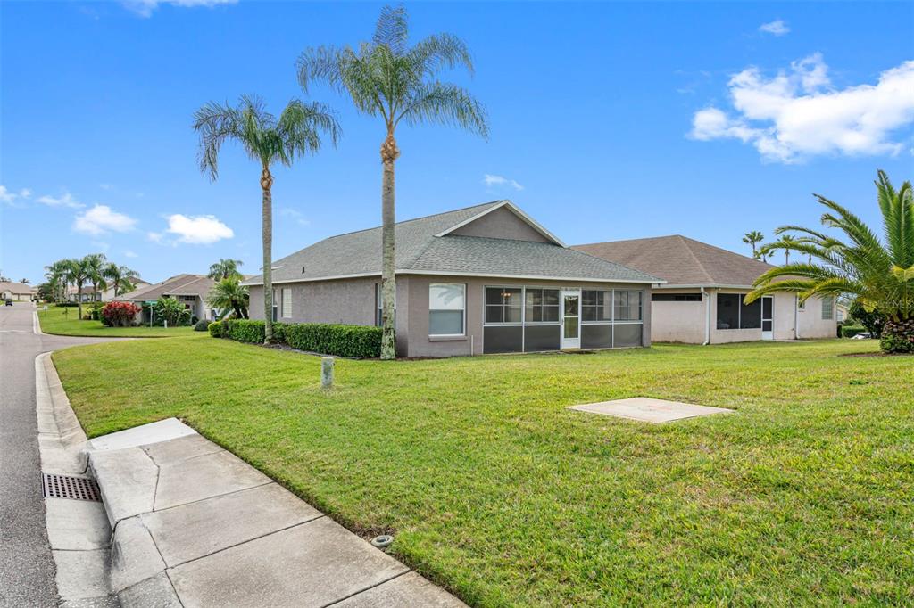 A single-story house with a screened-in porch and two palm trees in the front yard — 3063 WESTMORELAND DRIVE, LAKELAND, FL