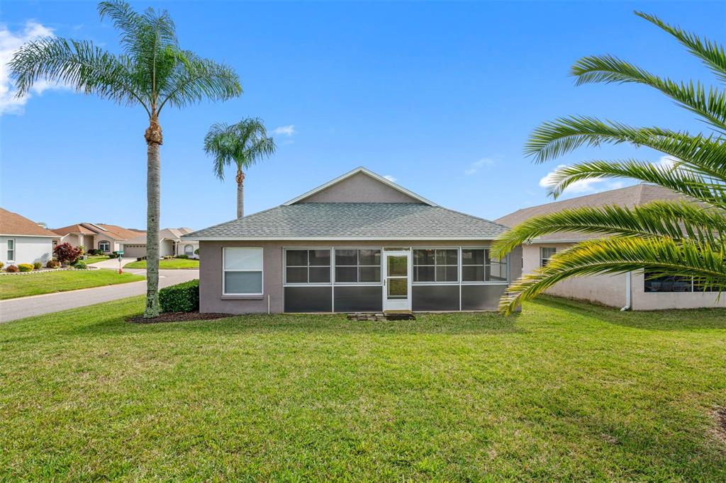 The exterior of a single-story house features a screened-in porch and two palm trees — 3063 WESTMORELAND DRIVE, LAKELAND, FL