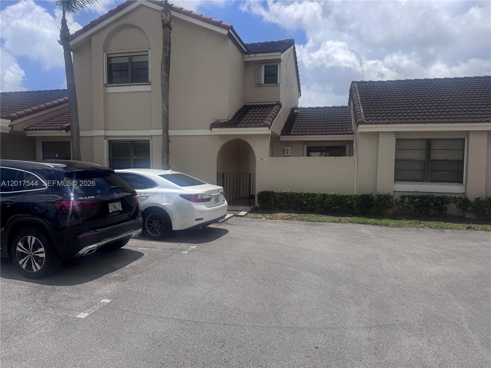 An outdoor parking space marked 7-4 is situated in front of a building with windows — 6532 NW 170th Ter, Hialeah FL 33015, HIALEAH, FL