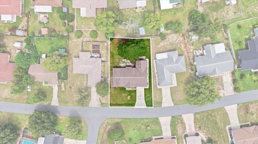 An aerial view shows a single-story house with a driveway and a large backyard tree — 3105 N RUNNING OAK TERRACE, BEVERLY HILLS, FL