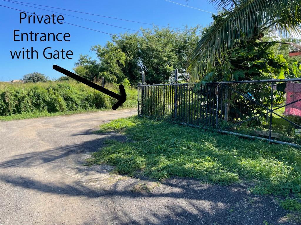 A dirt road leads to a metal gate marking a private entrance to a property — Lot E PR 110 AGUACATE, AGUADILLA, PR