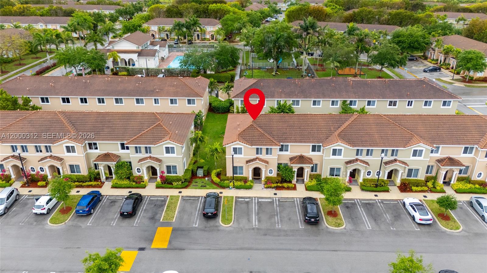 An aerial view shows a row of two-story townhouses with a red pin marking one unit — 2440 SE 10th Ct, Homestead FL 33035, HOMESTEAD, FL